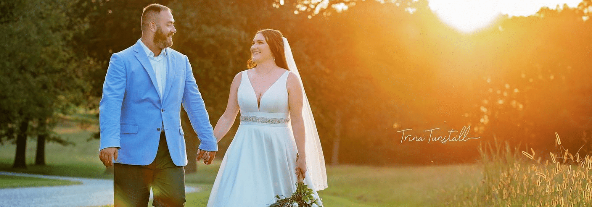 bride and groom holding hands in an open pasture 